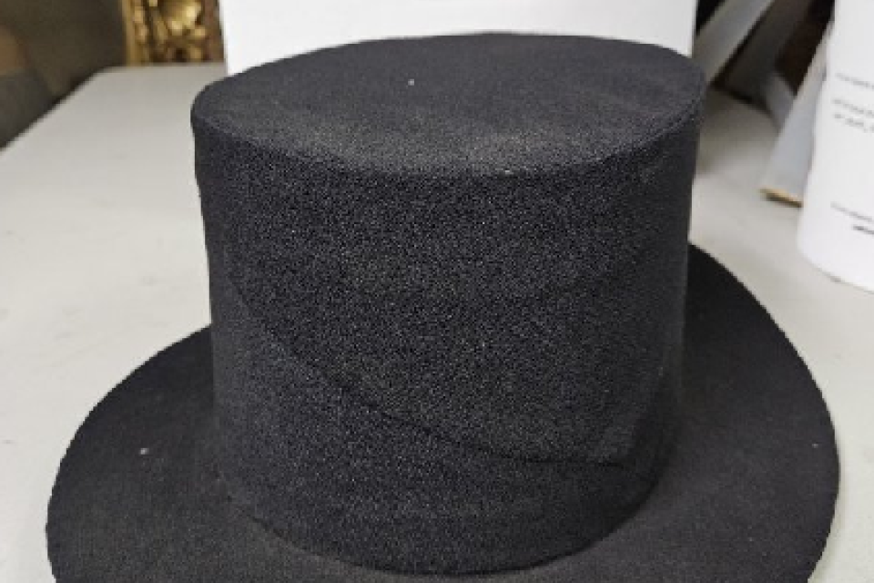 This black crepe hat with a high straight crown and flat brim was worn by Robert Bartless Dixon, a member of the Third Haven Meeting House. Contributed by members of the Talbot Historical Society.
