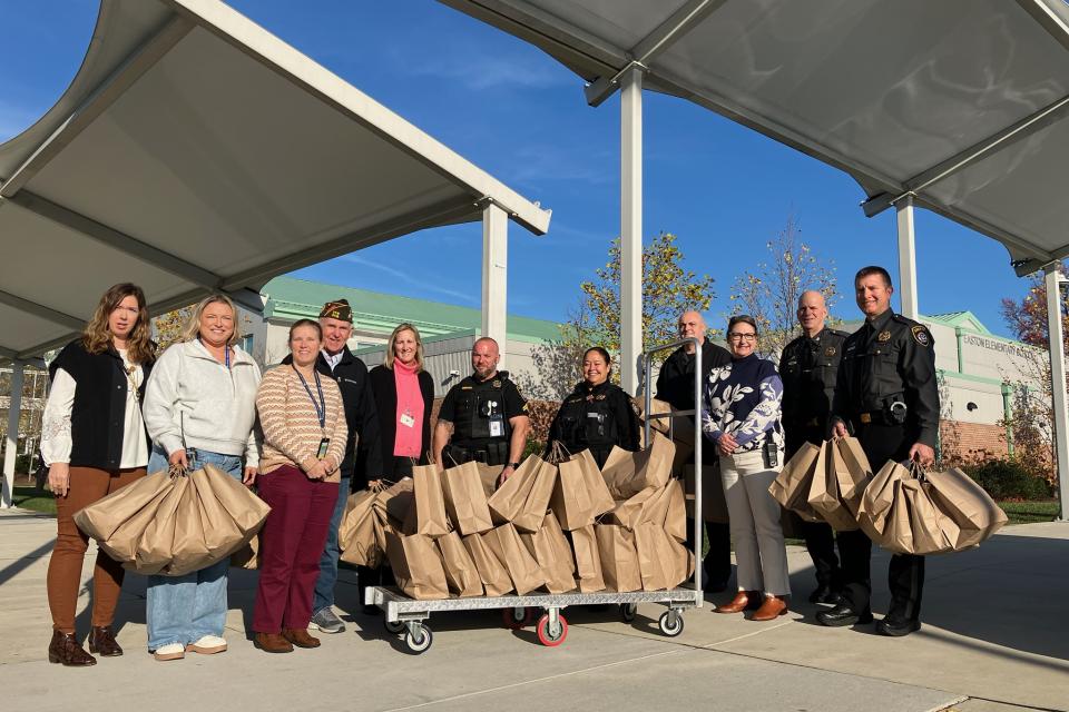 Partners drop off winter coats at Easton Elementary School.