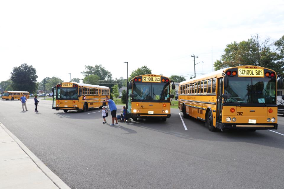 Students arrive by bus at Easton Elementary in 2023.