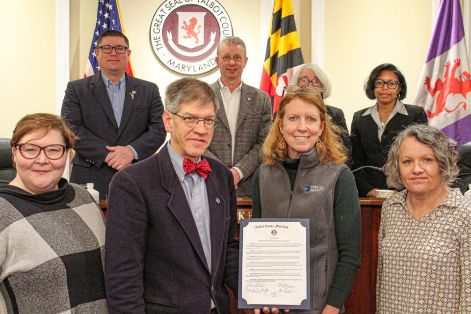 Front from left: Lauren Weber, Vice President of Strategy and Development, For All Seasons; Council Vice President Pete Lesher; Katie Theeke, Vice President of Marketing and Communications, For All Seasons; and Julie Crain, President, Harriett’s House.