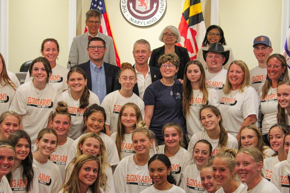 Elgin Hawley (standing center in the navy shirt).