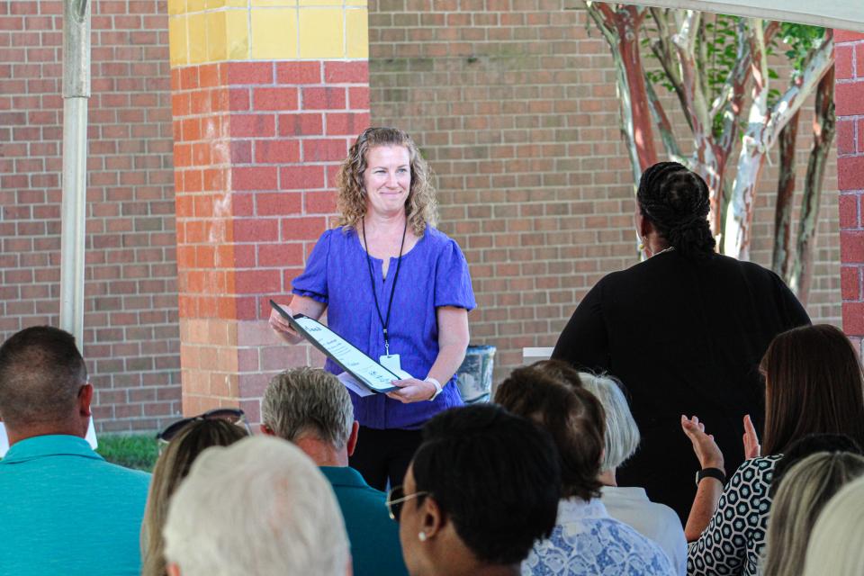 Lisa Vaughn, capital project manager for the commission, presents citation to Superintendent Sharon Pepukayi