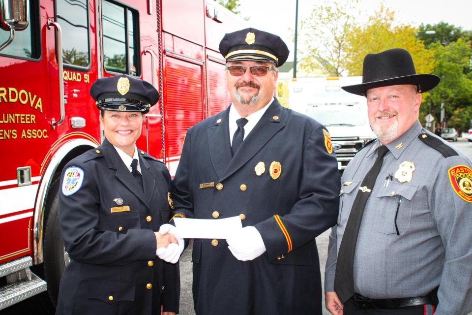 Tina Kintop, Division Chief of EMS, accepts a check for the Talbot FiRST™ program from Jimmy Eason, President of the Talbot County Volunteer Fire &amp; Rescue Association. From left: Tina Kintop; Jimmy Eason; Easton Police Chief Alan Lowrey.