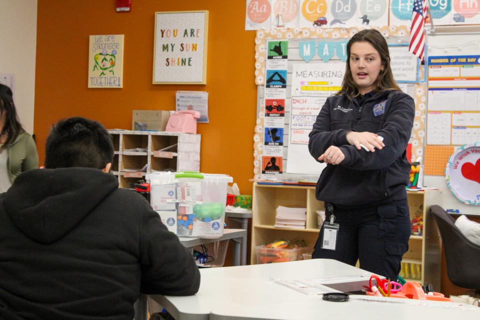 Loker demonstrates how to apply pressure to a wound, explaining you should clean a wound, apply pressure, and wrap up as necessary.